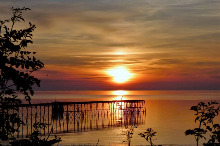 Mike Quine snapped this shot of sunrise over the Queen's Pier in Ramsey