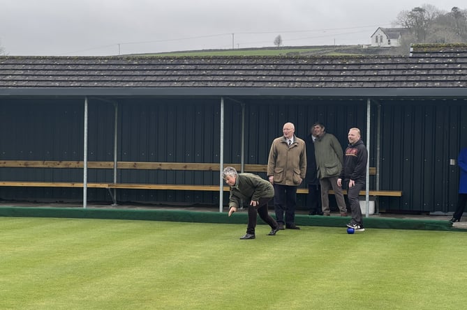 Lady Lorimer trying bowls in Marown as Sir John Lorimer and Marown Bowling Club chairman Neil Withers watch on