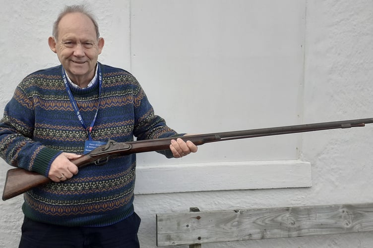 Museum Trustee Norman McGregor Edwards examining the historic musket on its arrival at the museum.