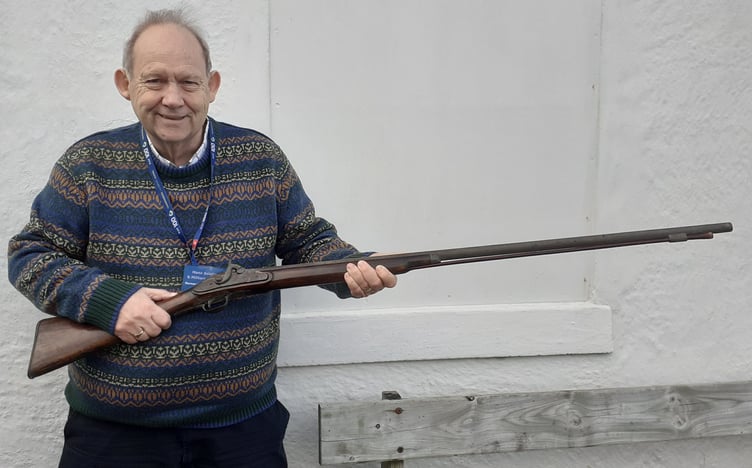 Museum Trustee Norman McGregor Edwards examining the historic musket on its arrival at the museum.