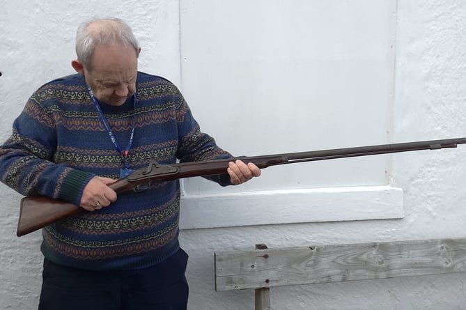 Museum Trustee Norman McGregor Edwards examining the historic musket on its arrival at the museum.