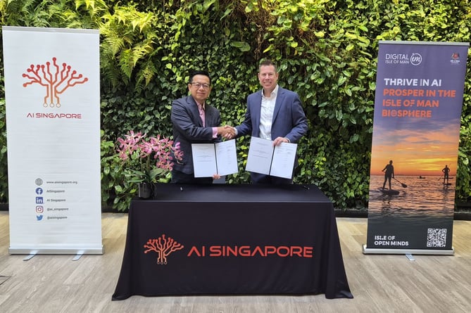 Lyle Wraxall, chief executive of Digital Isle of Man, and Laurence Liew, director of AI Innovation at AI Singapore signing the Memorandum of Understanding in Singapore 