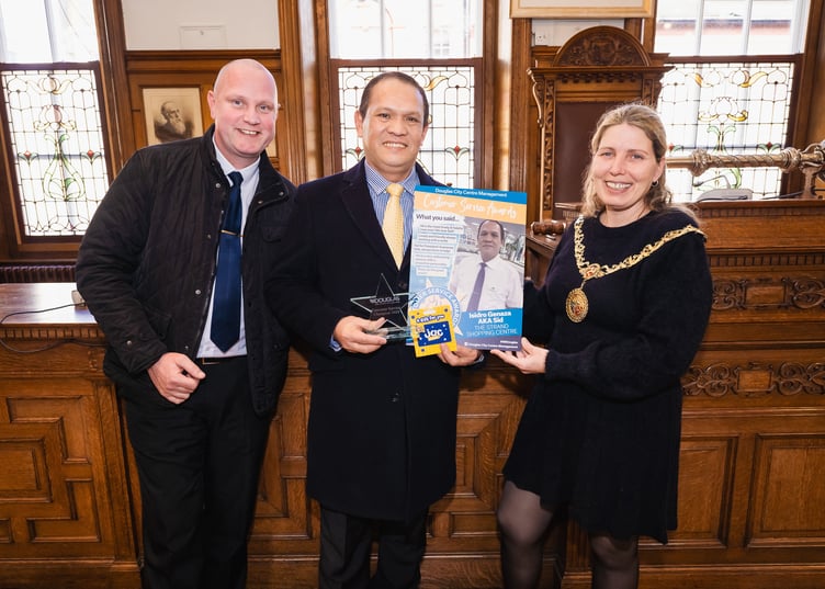 Wayne Robinson (Strand site manager), Isidro Genaza and Mayor Natalie Byron-Teare Douglas Customer Service awards