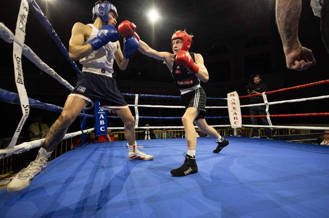 Manx ABC's Joe Faragher lands a punch on his opponent under the lights at the Villa (Photo: 3 Legs Photography/Joe Ricciardi)
