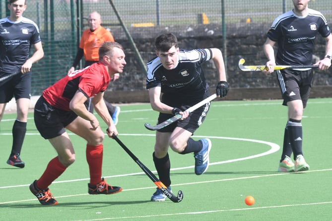 Vikings A captain Tom Burrows (right) chases the ball alongside Andy Wignall from Castletown A during Saturday's clash at King William's College (Photo: Dave Kneale)