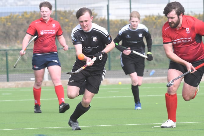 Vikings A's Macklin Wilson juggles the ball while Castletown A's Sam Sleight attempts to chase him down, watched on by Matty Gorry (Castletown) and Ben Dougal (Vikings) in the background (Photo: Dave Kneale)