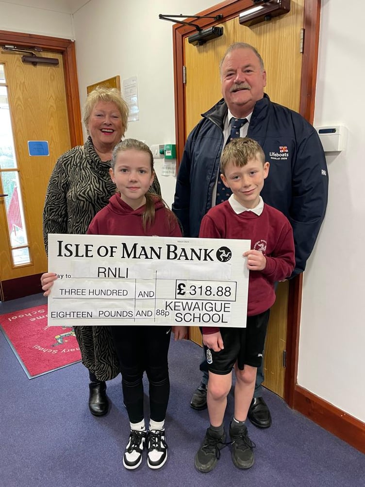 Gilli Cowley & Martyn Perkins receiving the cheque from two pupils