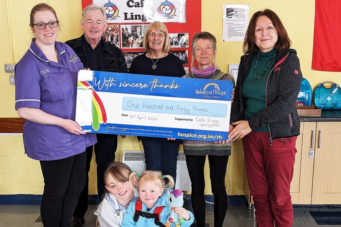 Rebecca House nursery nurse Kirree Norton (far left) is presented with a cheque for £140 from representatives of Cafe Lingo (left to right) Tim and Karen Norton, Sharon Jones Sullivan and Sylvie Géal-Wilkes. Also pictured at the front are Kirree's children Freya and Erin
