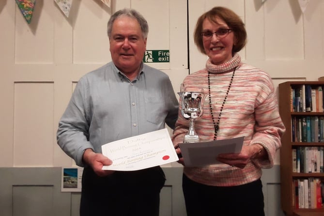 Jane Richardson is handed the Isle of Man Creamery Buttermilk Cup as World Bonnag champion by judge Tony Quirk