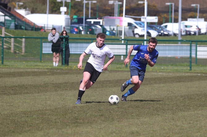 Corinthians' Nathan Little (left) looks to escape the attentions of DHSOB's Cian Geoghegan during Saturday's Hospital Cup clash at Ballafletcher (Photo: Paul Hatton)