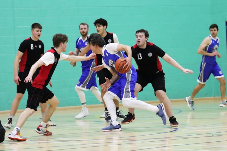 Wolves' Ben Takkan goes for the drive as Ravens' Matt Jones and Torryn Jones shift to block the lane during Thursday evening's semi-final at the NSC