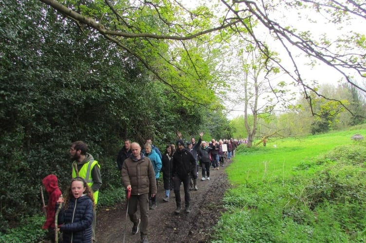 The demonstration march heads through Poyll Dooey fields