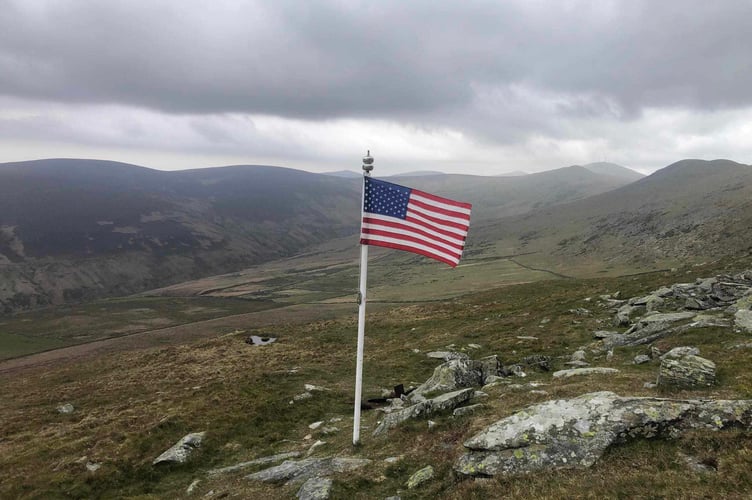 A USA flag flies at the crash site today (Tuesday)