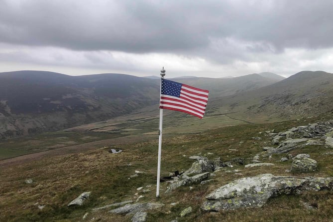 A USA flag flies at the crash site today (Tuesday)
