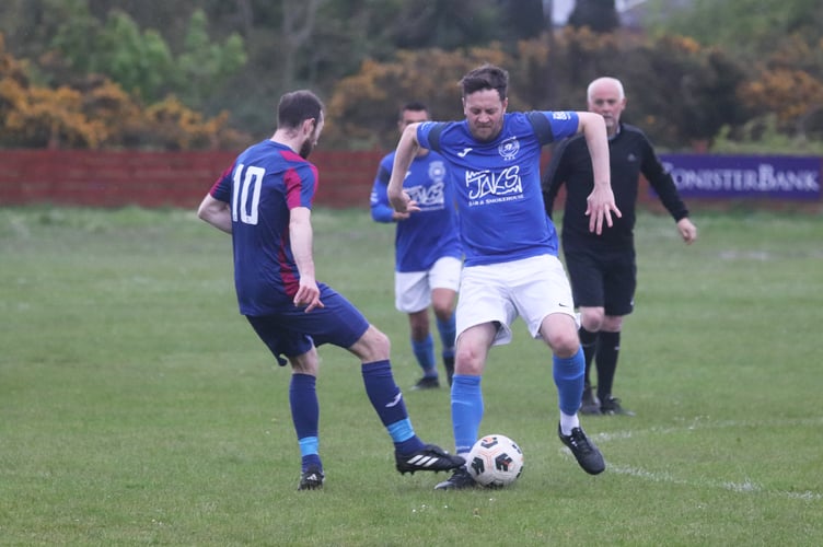 Foxdale's Liam Cannan (left) closes down DHSOB's Blane Slattery during Tuesday evening's DPS Ltd Division Two clash at Blackberry Lane (Photo: Paul Hatton)