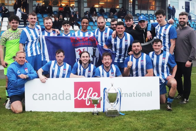 Ramsey players and coaches celebrate with the Canada Life Combination One league trophy after beating St John's 6-4 on Wednesday evening (Photo: Paul Hatton)
