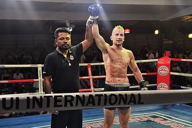 Joe Ashworth-Hayes has his armed raised by the referee after winning on his professional debut