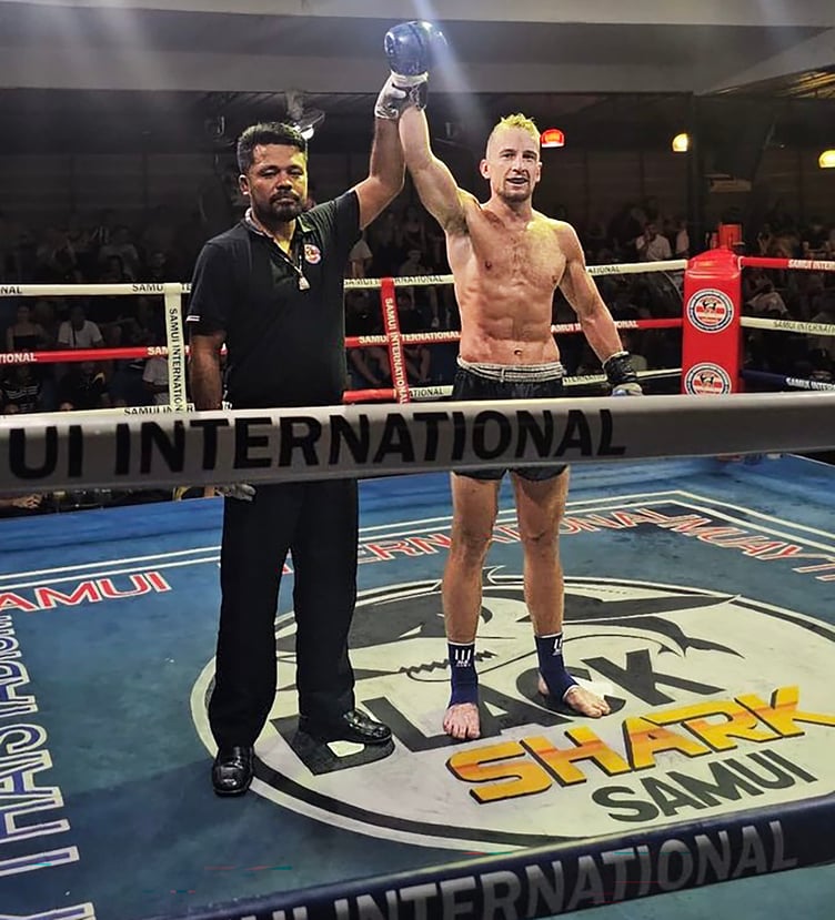 Joe Ashworth-Hayes has his armed raised by the referee after winning on his professional debut