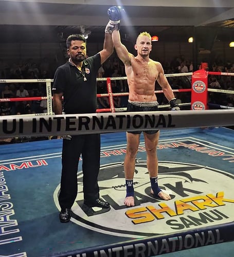 Joe Ashworth-Hayes has his armed raised by the referee after winning on his professional debut