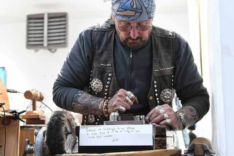 Kim Maurer, better known as Harley Kim, making rings out of silver spoons and resizing them onsite for customers
