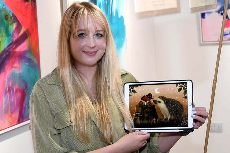 Illustrator Rowan Corlett with her work at the Finders Keepers artisan market