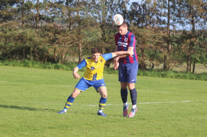 Onchan's Stephen Whitley (left) and Foxdale's Scott Kermeen compete for the ball during Tuesday evening's DPS Ltd Division Two clash at Colby (Photo: Paul Hatton)