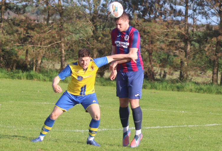 Onchan's Stephen Whitley (left) and Foxdale's Scott Kermeen compete for the ball during Tuesday evening's DPS Ltd Division Two clash at Colby (Photo: Paul Hatton)