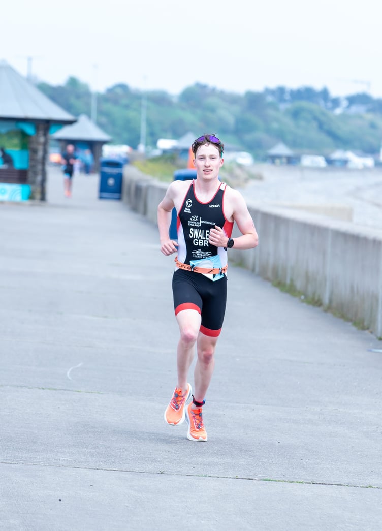With the finishline in sight on Mooragh Promenade, Island Games athlete Charlie Swales closes in on victory in the 1886 Sprint Tri on Sunday. He completed the swim, cycle and run in a combined total of 58 minutes 23 seconds (Photo: DK Photography)