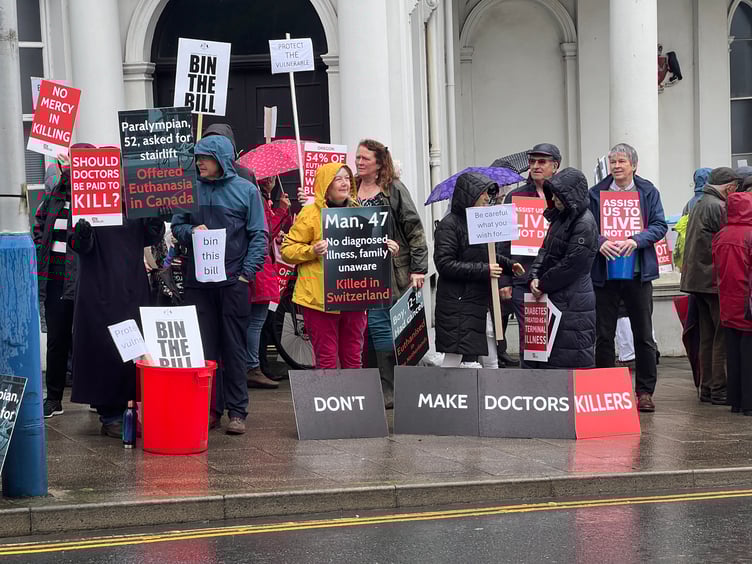 A number of those against the assisted dying bill outside Tynwald on Tuesday