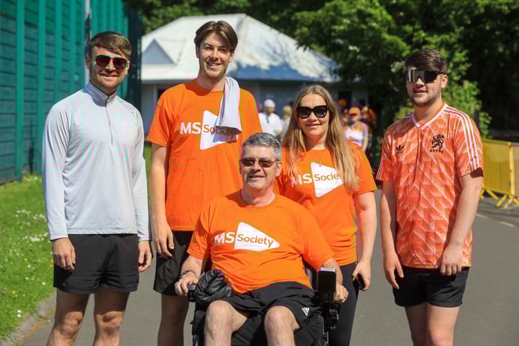 Participants of the Wheel and Walk fundraiser brandishing their orange shirts