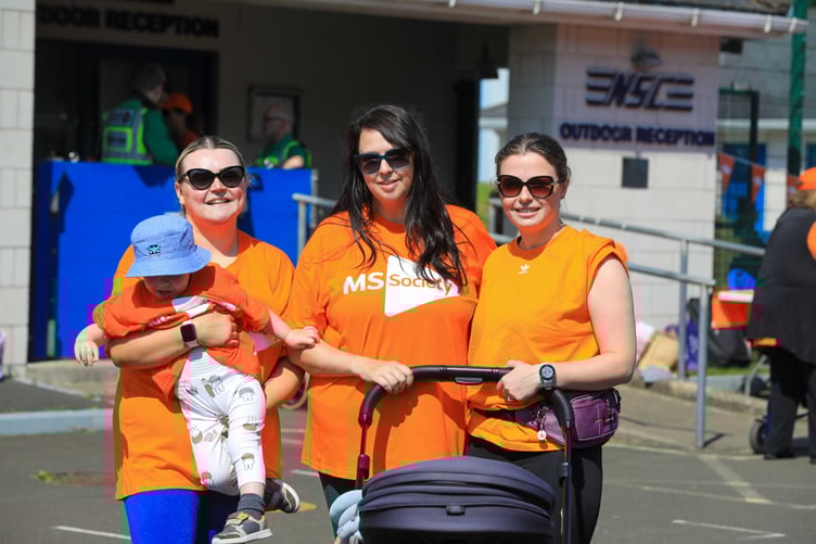 Participants of the Wheel and Walk fundraiser smile in the sunshine