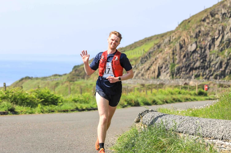 One competitor is in good spirits as he runs along Marine Drive