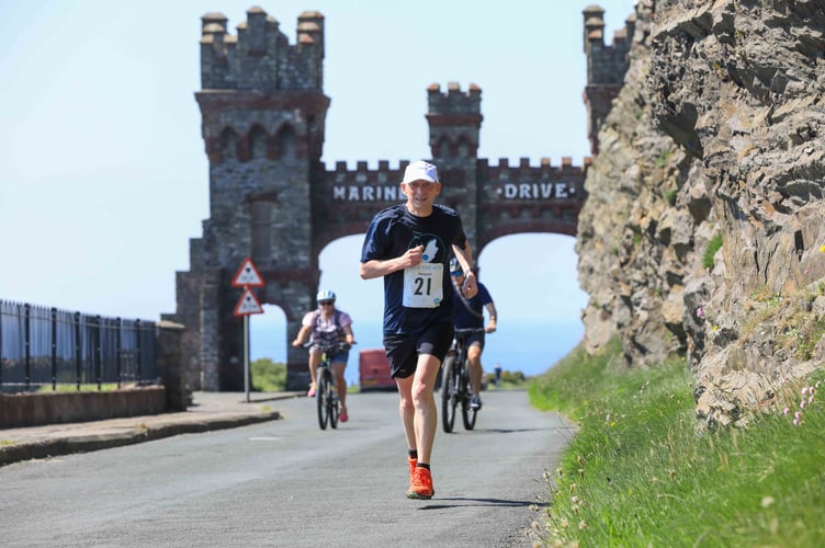 With the iconic Marine Drive gateway behind him, Nigel Armstrong heads into Douglas during the weekend's Atla-sponsored Race the Sun event which raised money for the Children's Centre. Running for Hansard, Armstrong clocked the sixth quickest time on the Port Grenaugh to Douglas leg to help his team finish second overall in a combined time of 	12 hours 38 minutes 33 seconds. More in Thursday's Manx Independent