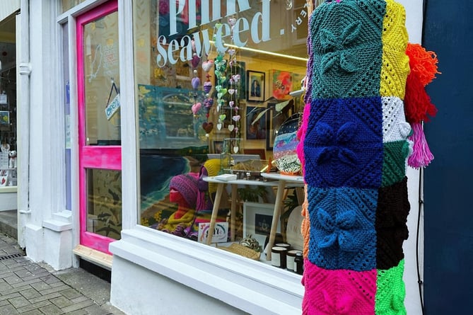 Yarn wrap on lamp post outside the Pink Seaweed was removed for safety reasons