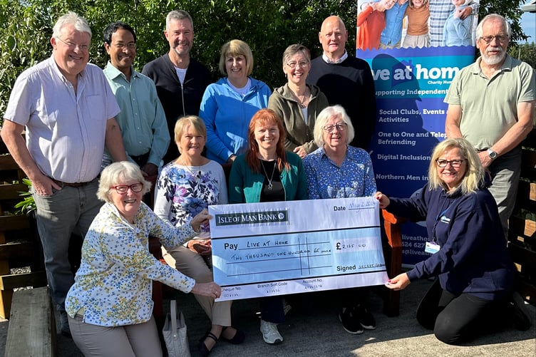 Ellen Callister and Rachel Vickers present cheques to Sight Matters and Live at Home on behalf of the Onchan Secret Gardens group
