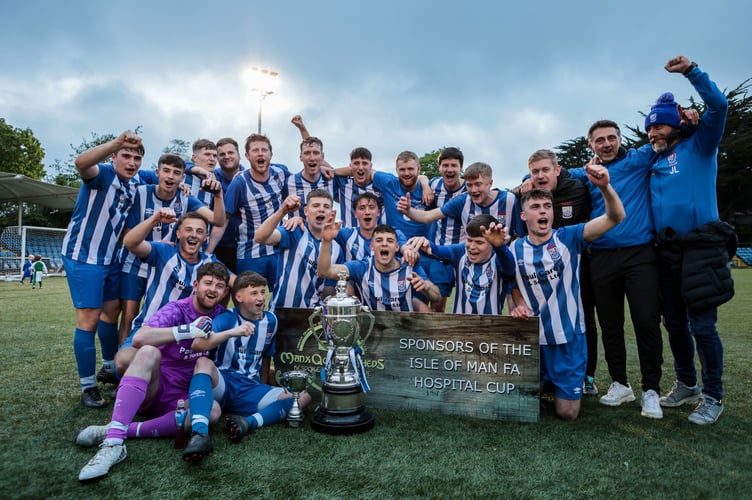 Ramsey AFC players and coaches celebrate with the Hospital Cup after beating Laxey 2-1 in the final of the Manx Quality Sheds-sponsored competition on Friday evening (Photo: Gary Weightman)