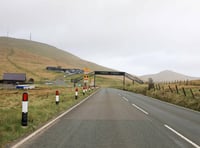 Two people receiving medical treatment on Mountain Road after crash