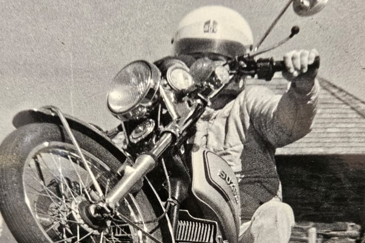 Pat Hennen wheelies Allan Lund’s GT380 past the Mountain Box during an initial visit to the island in early 1977, prior to making his TT debut (Photo: Doug Baird)