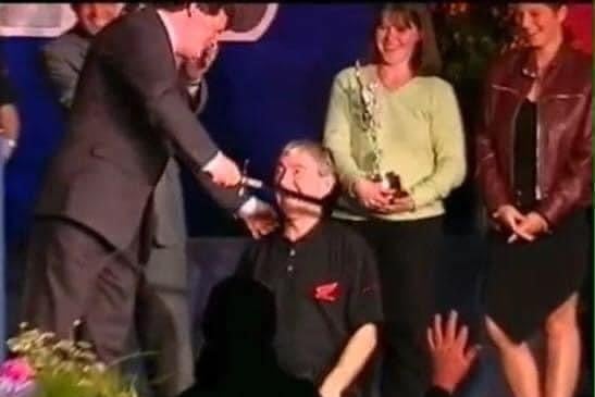 David Cretney 'knighting' Joey Dunlop with a replica Manx sword