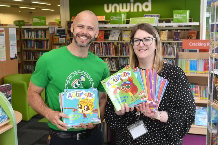 Actiphons, a series of educational children's books, are donated to the Henry Bloom Noble library in Douglas by their creators - pictured is Actiphons co-creator Simon Austerberry and Douglas city librarian Sophie Goodwin