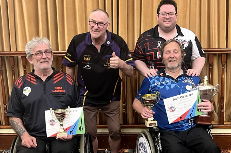 Darren Kennish (front right) with his BDDA Welsh Open trophies alongside runner-up Ian Lewis. Also pictured are Pete Bramley, who was the caller for the final, and fellow Darts GB official Matt Doe