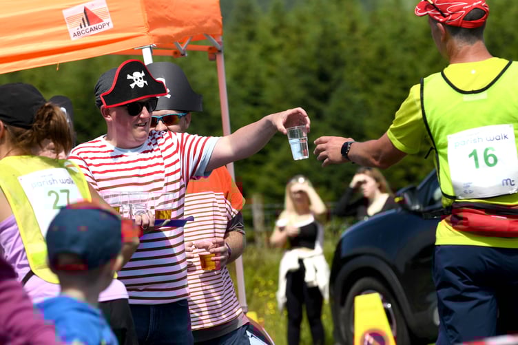 Cups of water being offered at the Round Table in South Barrule