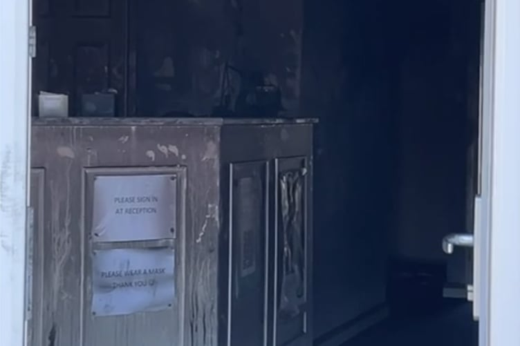 An open door shows the damage inside the building