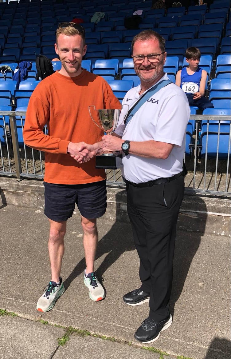 Olympic race walk judge Steve Taylor (right) is presented with the Baker Tilly Spirit of Athletics award in recognition of his contribution to athletics in the Isle of Man. He received the award from athletics development officer Ollie Lockley (Photo: Claire Turner)