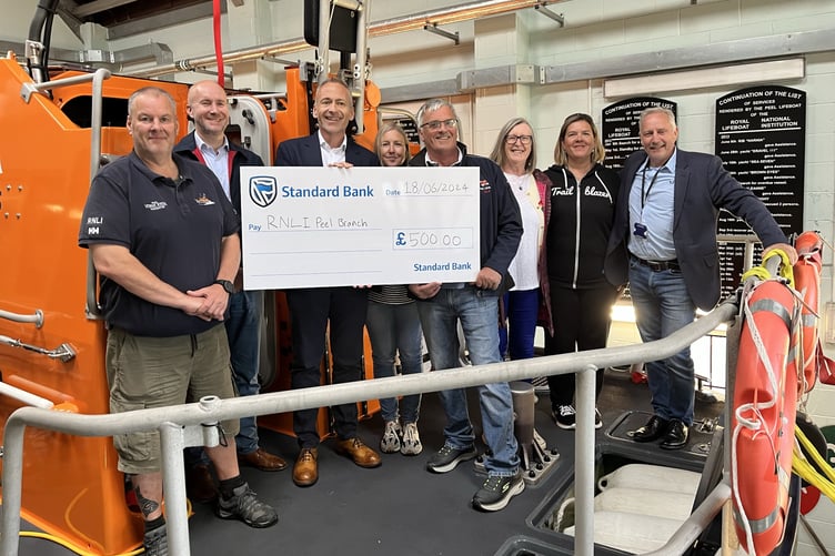 RNLI volunteers with Standard Bank representatives at Peel Lifeboat Station