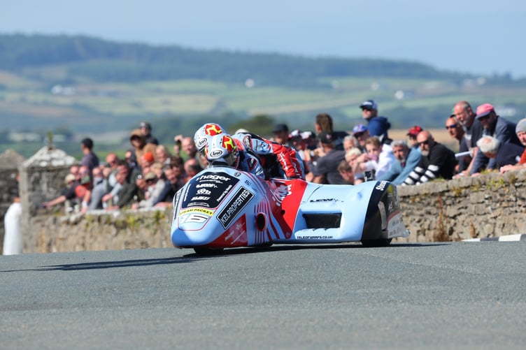Ben Birchall and Kevin Rousseau on their way to victory in the sidecar championship race at the Southern 100 on Thursday afternoon