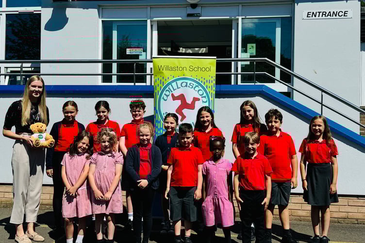 Willaston School's IQM lead Abbie Irving with pupils celebrating after receiving a prestigious award