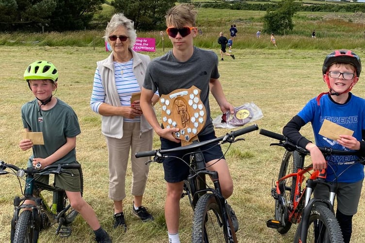 Daniel Minay (centre) won the Brian Quirk Memorial Shield bike race. He's pictured with Thomas Cregeen and Callum Quirk plus Wendy Quirk who presented the prizes