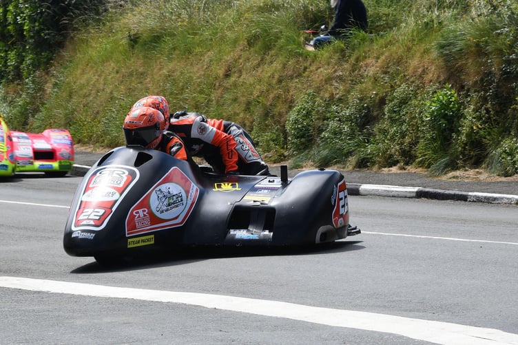 Mike Russell and local passenger Jake Roberts finished third in the first sidecar race, pictured here leading Greg Lambert and Andrew Haynes at Ballabeg (Photo: Richard Radcliffe)