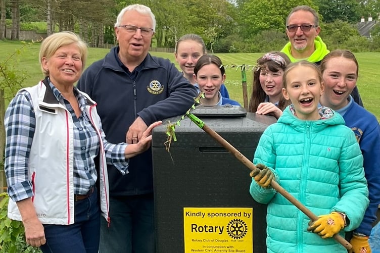 Rotary Club of Douglas members Mary Jane Falconer and Howard Callow, with Mike Rose (manager of the Western Civic Amenity site) and children from Arbory Primary School